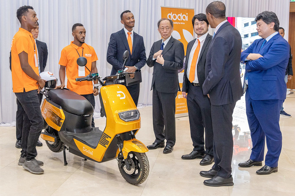 In front of actual electric mobility equipment at a conference attended by DODAI held in Ethiopia